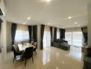 Spacious and modern living room with dining area and glossy tiled flooring