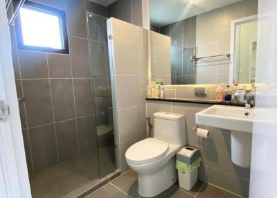 Modern bathroom with walk-in shower and grey tiles