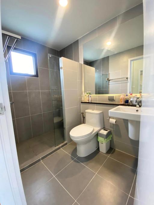 Modern bathroom with walk-in shower and grey tiles