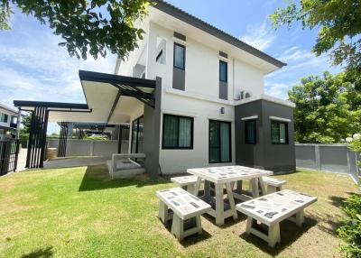 Modern two-story house with exterior lawn and patio