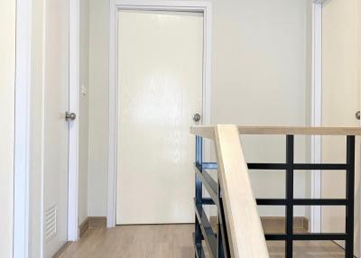Modern hallway with wood laminate flooring and white doors