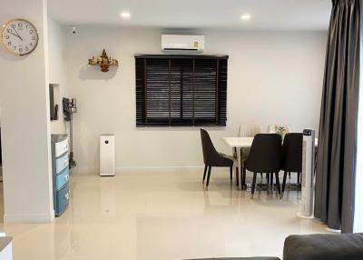 Modern and well-lit living room with dining area