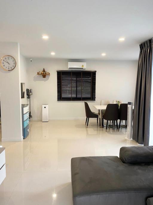 Modern and well-lit living room with dining area