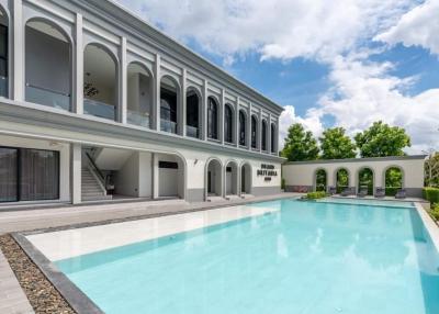 Luxurious two-story building with a large swimming pool