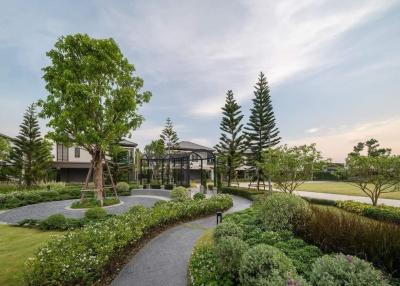 Lush greenery in a well-manicured outdoor communal space of a modern housing complex