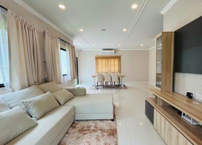 Spacious and modern living room with open floor plan connecting to the dining area