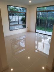 Bright and spacious empty living room with large windows and glossy tiled floor