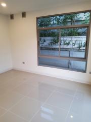 Bright empty room with large window and tiled floor