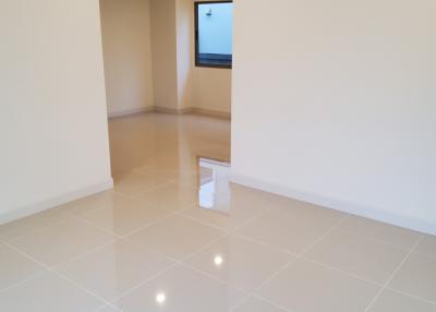 Bright empty room with glossy floor tiles and recessed lighting