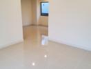 Bright empty room with glossy floor tiles and recessed lighting