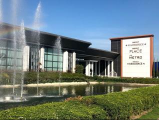 Modern exterior of a residential building with landscaped front and water fountain