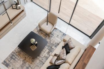 Modern living room with open space design, high ceilings, and minimalist furniture