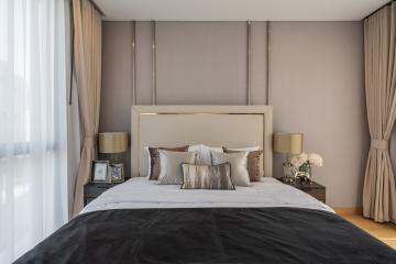 Elegant modern bedroom with neutral tones and luxurious bedding