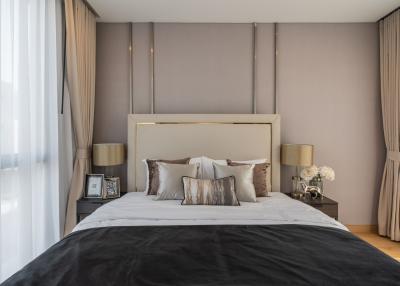 Elegant modern bedroom with neutral tones and luxurious bedding