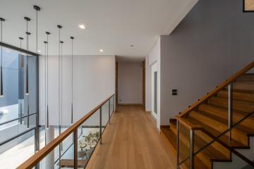 Modern hallway with wooden flooring and staircase