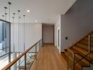 Modern hallway with wooden flooring and staircase