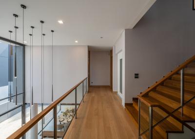 Modern hallway with wooden flooring and staircase