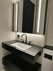 Modern bathroom with sleek sink and lit mirror