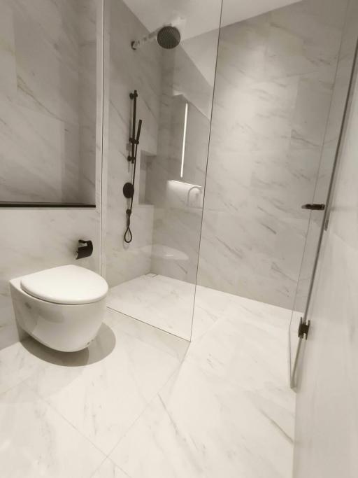 Modern bathroom with marble finish and glass shower