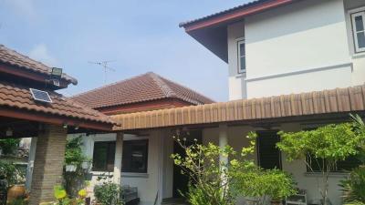 Spacious residential home with tiled roofing and green garden