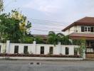 Spacious family home with landscaped front yard and a terracotta roof