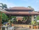 Cozy house exterior with terracotta tile roofing and a thriving garden