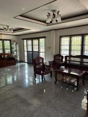 Spacious and bright living room with glossy floor and traditional furniture