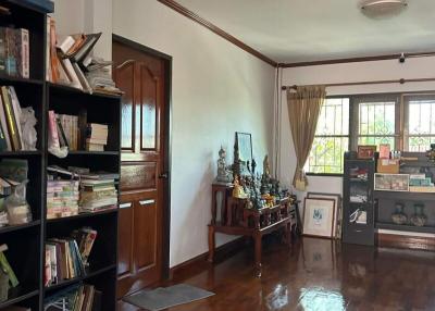 Spacious living room with wooden flooring and bookshelf