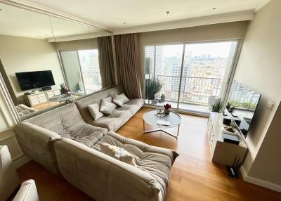Spacious and well-lit living room with modern furnishings and city view