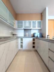 Modern kitchen with marble countertops and ample cabinetry