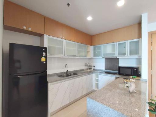 Modern kitchen with marble countertop and well-equipped appliances