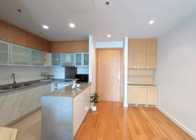 Modern kitchen with wooden flooring and marble countertops