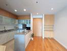 Modern kitchen with wooden flooring and marble countertops