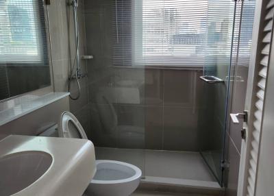Modern bathroom with glass shower and ceramic fixtures