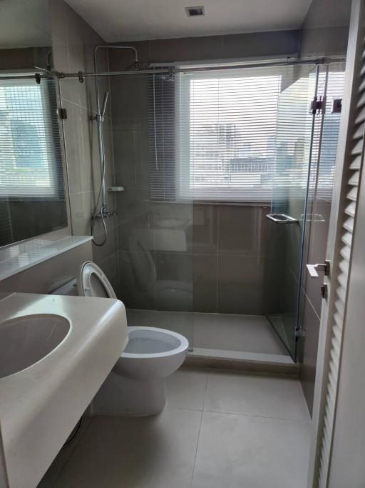 Modern bathroom with glass shower and ceramic fixtures