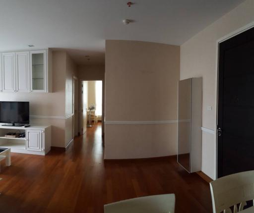 Spacious living room with natural light and wooden flooring