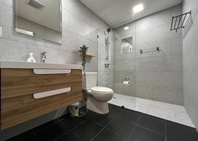 Modern spacious bathroom with walk-in shower and stylish vanity