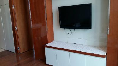 Modern living room interior with mounted television and white cabinetry