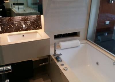 Modern bathroom with a bathtub, sink, and glass shower