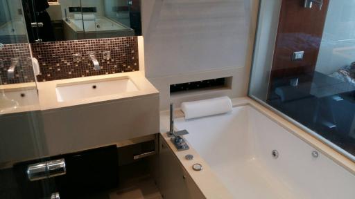 Modern bathroom with a bathtub, sink, and glass shower