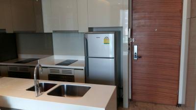 Modern kitchen with stainless steel appliances and wooden finishes