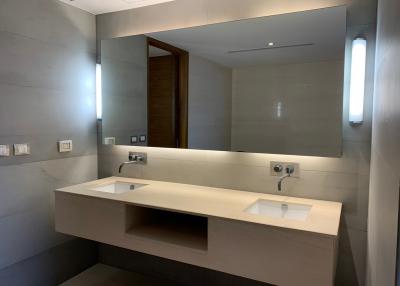 Modern spacious bathroom with dual sinks and large mirror