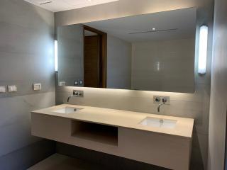 Modern spacious bathroom with dual sinks and large mirror