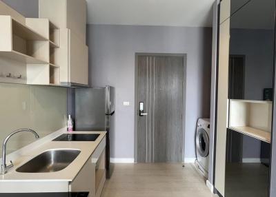 Modern kitchen with built-in appliances and beige tiling