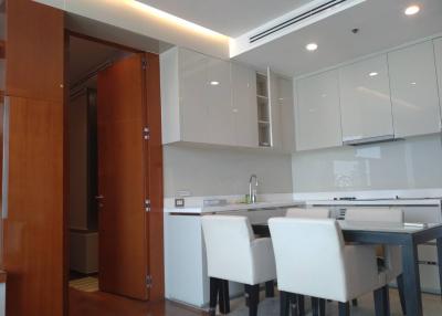 Modern kitchen with open dining area and white cabinetry