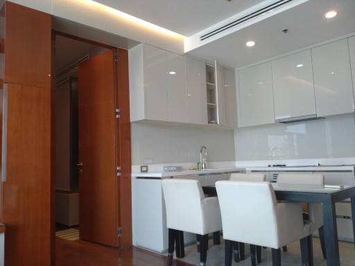 Modern kitchen with open dining area and white cabinetry