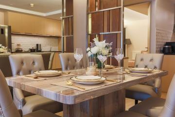 Elegant dining room with a modern table set and open concept kitchen