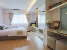 Spacious bedroom with natural light, modern decor, and mirrored wardrobe