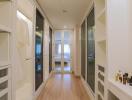 Modern hallway leading to a well-lit bedroom with glass doors