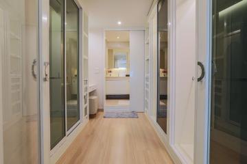 Spacious hallway with wooden floors and glass doors